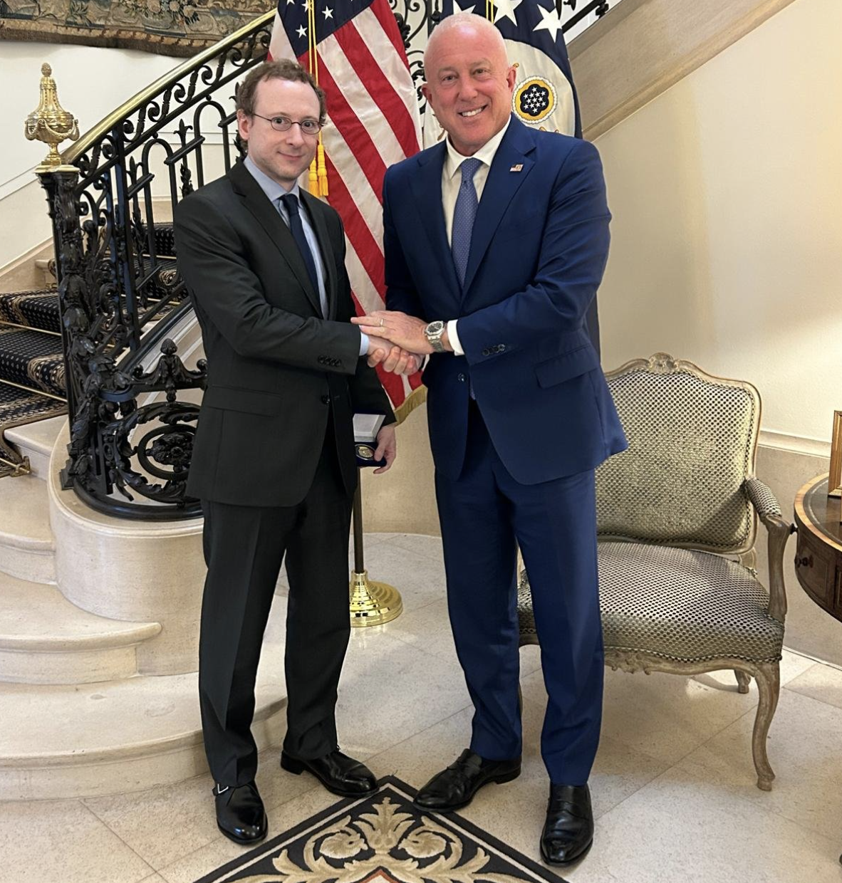 Nathan Cofnas shaking hands with U.S. Ambassador to Belgium Bill White